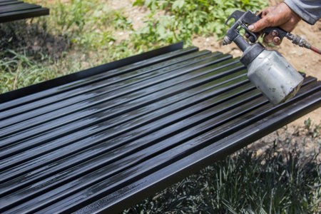 Close up painter are painting iron by spray.の写真素材