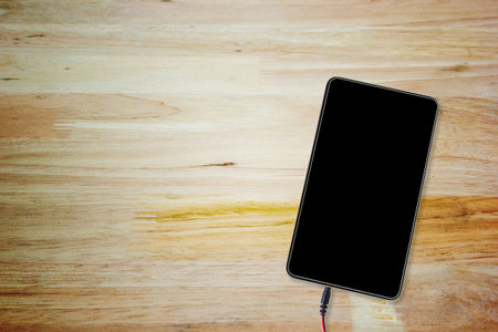 Tablet on wooden table with copy space from top viewの写真素材