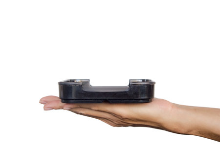 Hand holding black plate isolated on white background. Clipping path.の写真素材
