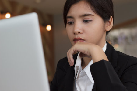 Serious business woman use laptop working in office or coffee shop.の写真素材