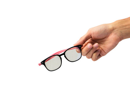 Man hand holding glasses isolated on white background with clipping path.の写真素材