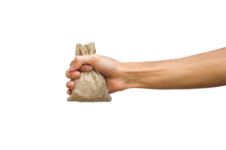 Man hand holding moneybag, brown sackcloth isolated on white background with clipping path.の写真素材