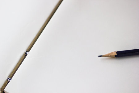 Opened notebook with pencil background with copy space. Black pencil on opened empty notebook for writing, memo, check list, diary.の写真素材