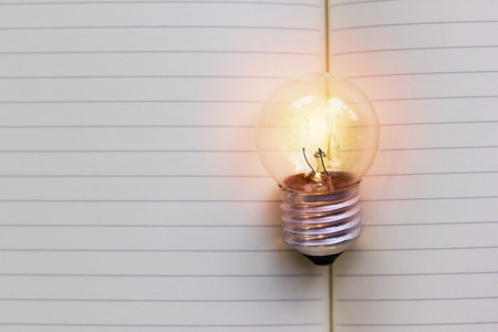 Creative thinking, idea, business concept : Light bulb put on open notebook with blank space....