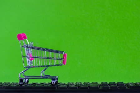 Online shopping, eCommerce or order online concept : Empty shopping cart ready to shop on black keyboard Ordered by customer through the media via internet show that trading is quick and easy.の写真素材