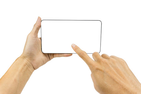 Man hand holding Very slim black horizontal smartphone or tablet with white screen for mock up design. isolated on white background. Carefully cut out by pen tool and clipping path include.の写真素材