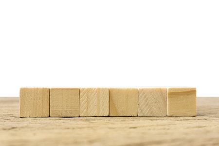 Horizontal 6 blank wooden blocks on table on white background for text copy space.