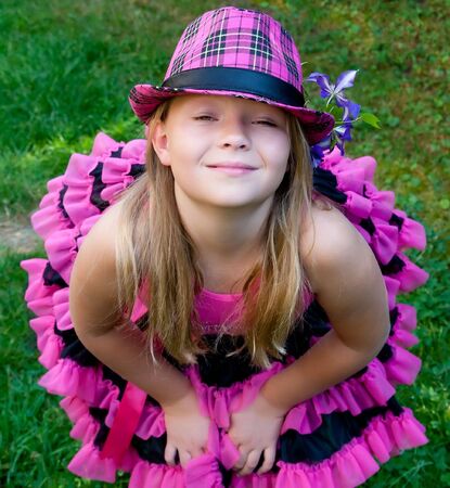 portrait of beautiful  little girl with hat in the gardenの写真素材
