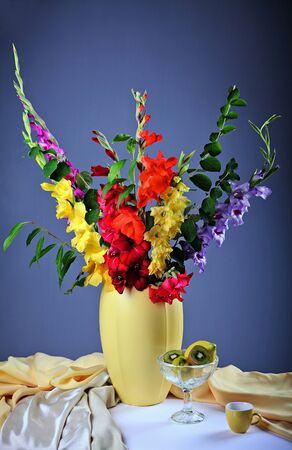 Still life with colorful  gladioluses and fresh fruitsの写真素材