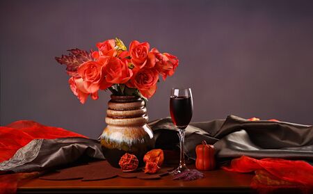 Still life with red wine and rosesの写真素材