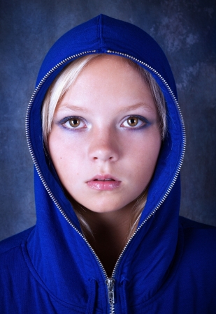 Portrait of young beautiful teen girl in blue hoodの写真素材