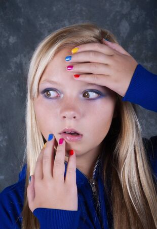 Very surprised beautiful  girl with hands which has colored nailsの写真素材