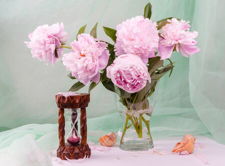 Still life with beautiful pink peonies in a glass vaseの写真素材