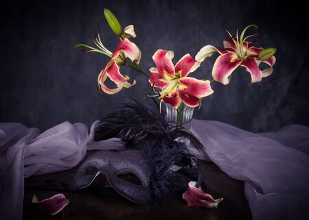 Still life with pink lily flowers in a glass vaseの写真素材