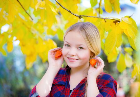 Beautiful  girl holds the fysalis in handの写真素材