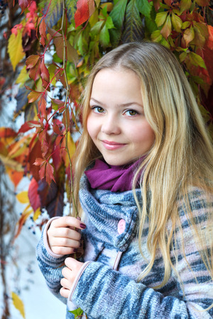 Portrait of beautiful young girl  in autumnの写真素材