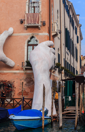 VENICE, ITALY - JANUARY 06, 2018: Sculpture: Monumental Gigantic hands rise from water to support the building. This powerful report on the climate change from the artist Lorenzo Quinnのeditorial素材