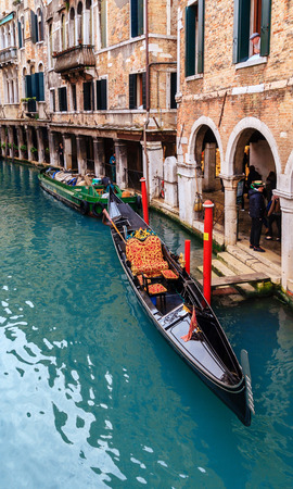 VENICE, ITALY - JANUARY 05, 2018: Typical gondola at narrow venetian canal during winter days, Venice, Italyのeditorial素材