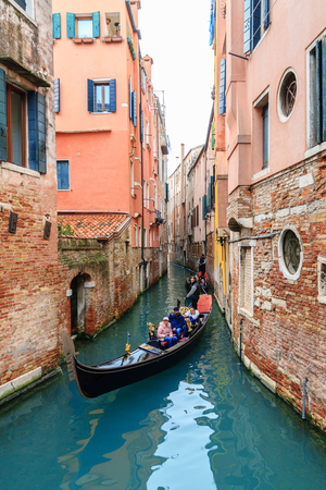 VENICE, ITALY - JANUARY 05, 2018: Typical gondola at narrow venetian canal during winter days, Venice, Italyのeditorial素材
