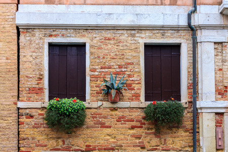 View of old window in historical buildings in Venice, Italyの写真素材