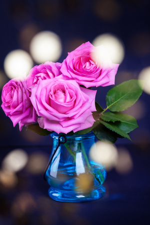 Bouquet of fresh pink roses  with bokeh lightsの写真素材