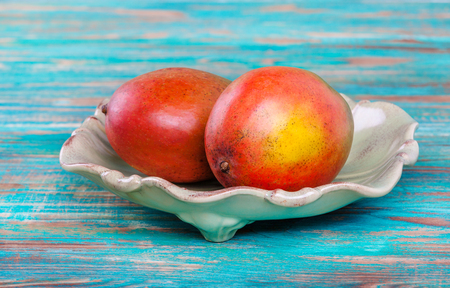 Mango tropical fruits on  wooden tableの写真素材