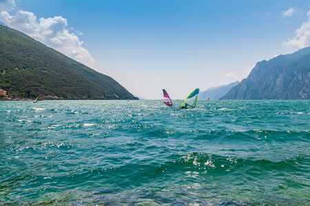 Nago Torbole, Lago di Garda (Lago Benaco), Italy - June 18, 2019. A windsurfing on Lake Garda in Torbole resort. Recreational Water Sports.のeditorial素材