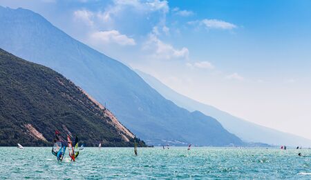 Nago Torbole, Lago di Garda (Lago Benaco), Italy - June 18, 2019. A windsurfing on Lake Garda in Torbole resort. Recreational Water Sports.のeditorial素材