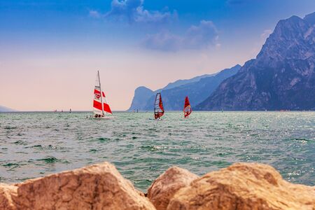 Nago Torbole, Lago di Garda (Lago Benaco), Italy - June 18, 2019. A windsurfing on Lake Garda in Torbole resort. Recreational Water Sports.のeditorial素材