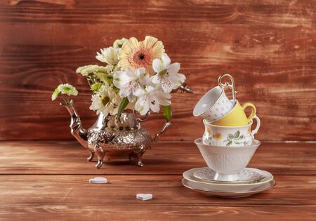 Stack of vintage tea cups on wooden backgroundの写真素材