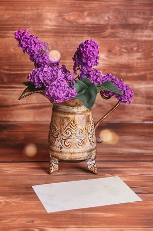 lilac in vintage vase on old wooden backgroundの写真素材