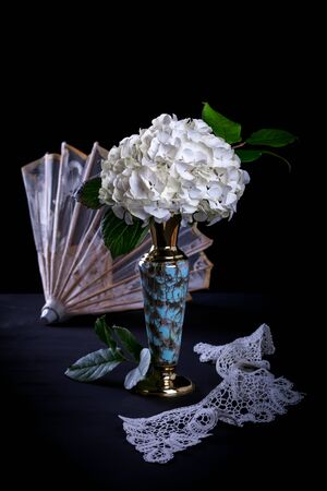 White hydrangea in vase on black backgroundの写真素材