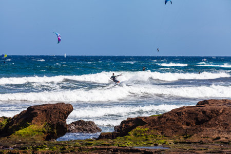 El MÃ©dano, Tenerife, Canary Islands, Spain â€“ 01.03.2026: Kitesurfer riding waves in the...