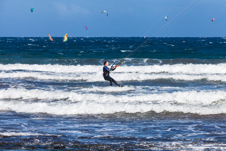 El MÃ©dano, Tenerife, Canary Islands, Spain â€“ 01.03.2026: Kitesurfer riding waves in the...