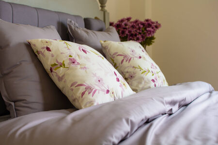 Vintage style pillows on a bed.の写真素材