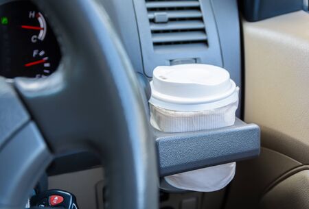 hot coffee to go at cup holder in a car.の写真素材