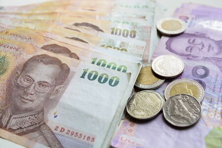 thai money bath banknotes with coins.の写真素材
