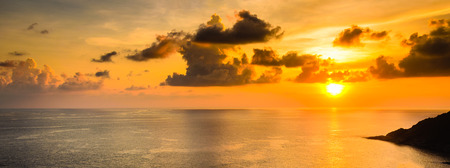 dramatic sunset at sea with cloudy skyの写真素材