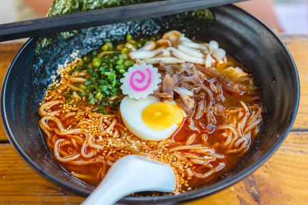 Spicy Japanese ramen noodle soup with egg, Japanese food culture.の写真素材
