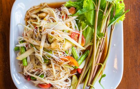 Papaya salad or Som Tum, Thai cuisine spicy one of famous street Thai food.の写真素材