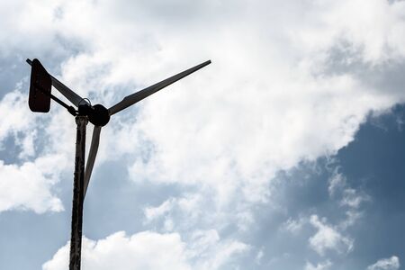 Old and weathered wind turbine generating electricity.の写真素材