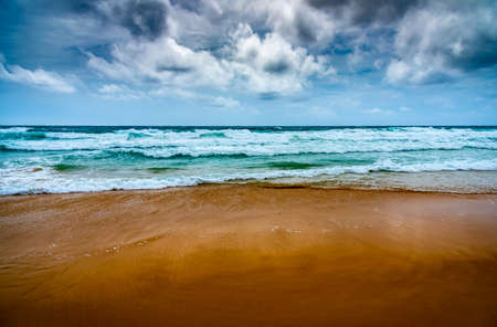 Beach and sea with overcast sky in windy day.