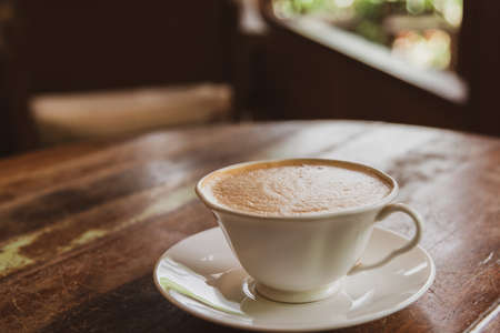 Hot arabica coffee latte with latte art in white cups for morning refreshment at coffee shop.の写真素材