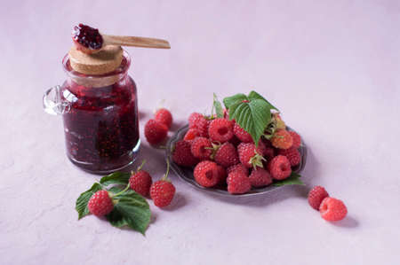raspberry jam in a jar and raspberries on a saucer, alternative medicine