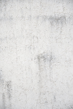 background, gray-white plastered wall with cracks and gray streaksの写真素材