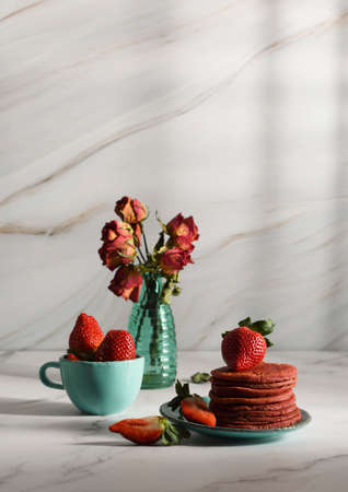still life with Pink strawberry pancakes on a turquoise plate with sour cream