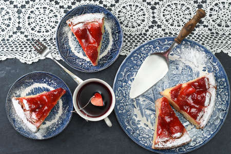 Valentines day, red strawberry pie on blue plates and a gift in a red box