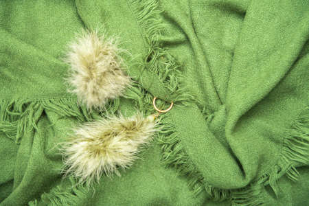 bright green scarf with fringe, natural background, fashion accessory for autumnの写真素材