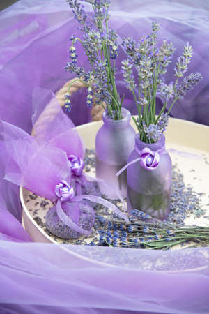 Lilac lavender in vases and lavender sachets,chiffon bags on a tray,still lifeの写真素材