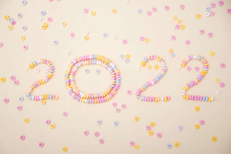 figures of the year 2022 lined with pastel colors candies letteringの写真素材